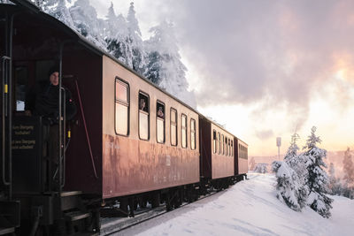 Train on railroad track against sky during winter