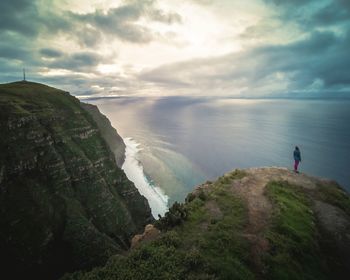 Scenic view of sea and mountains against sky