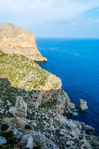 Scenic view of rocks in sea against sky