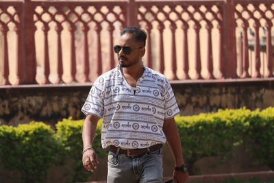 Portrait of young man standing in park