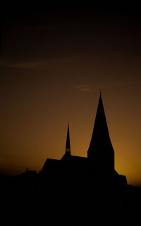 Low angle view of church against sky at sunset