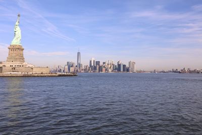 Statue of liberty against sky in city