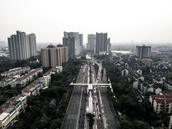 High angle view of street amidst buildings against clear sky