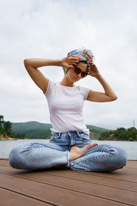 Woman wearing sunglasses sitting outdoors