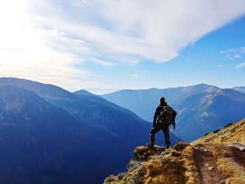 Man standing on mountain against sky