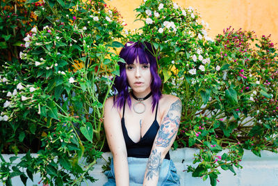 Thoughtful woman sitting alone outdoors. young worried in backyard