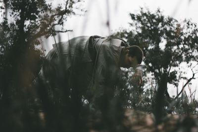 Side view of man working on field