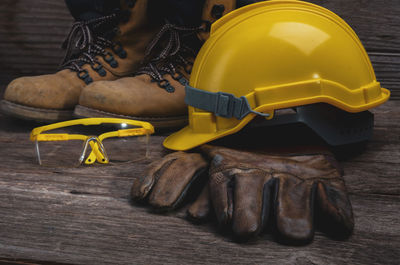 Low section of man standing on wood