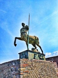 Low angle view of statue against blue sky