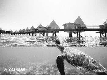 Built structure by sea against sky