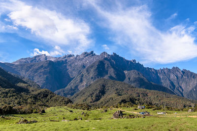 Scenic view of mountains against cloudy sky