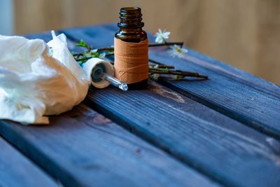 Close-up of medicine bottle and tissue paper on table