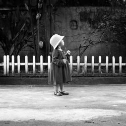 Woman standing with umbrella