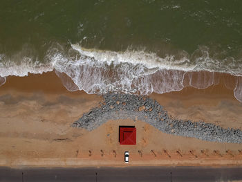 Information sign on beach by sea