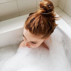 High angle view of girl in bathtub