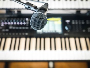 Close-up of microphone against piano