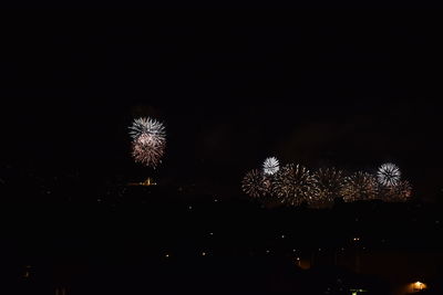 Low angle view of firework display at night