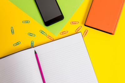 High angle view of yellow and book on table