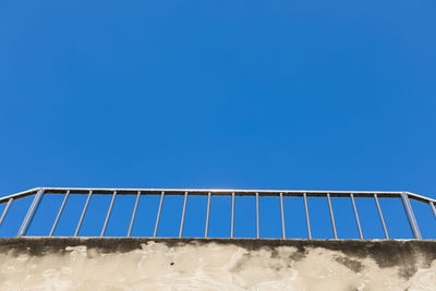 Low angle view of beach against clear blue sky