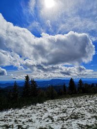 Scenic view of snow covered landscape against sky