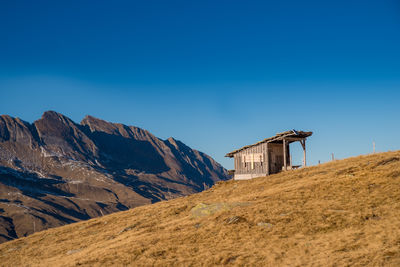 Scenic view of mountains against clear blue sky