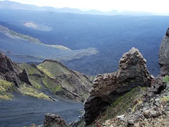 Scenic view of sea and mountains against sky