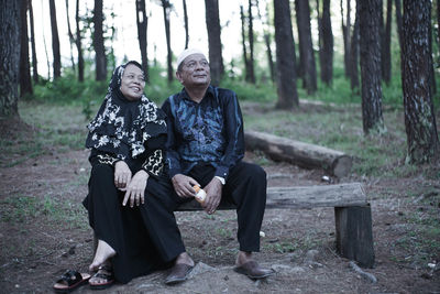 Full length of a man sitting in forest