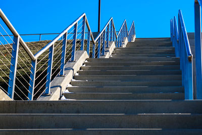 Low angle view of stairs against blue sky