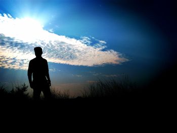 Silhouette of man standing against sky during sunset