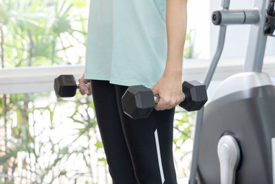 Midsection of woman exercising in gym