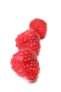 Close-up of red fruit over white background