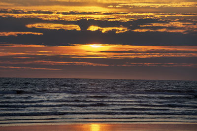 Scenic view of sea against romantic sky at sunset