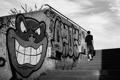 Graffiti on wall against sky