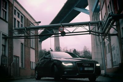 Cars parked on road by buildings in city