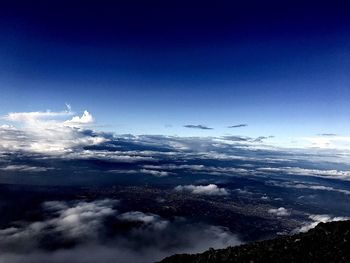 Aerial view of mountain range against cloudy sky