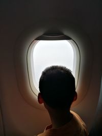 High angle view of man standing by airplane window