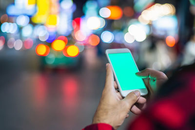 Cropped hands of woman using mobile phone