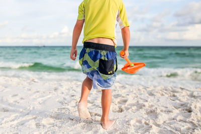 Rear view of boy on beach