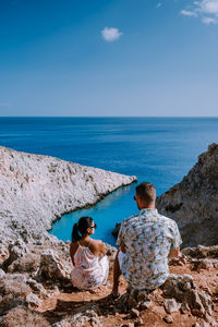 Rear view of couple looking at sea against sky