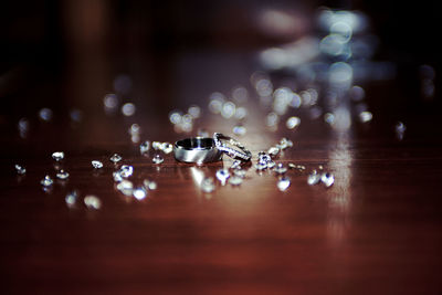 Wedding rings surrounded with diamonds on table