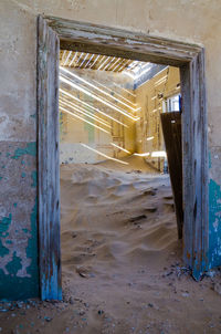 Abandoned house filled with sand at former german mining town kolmanskop near luderitz, namibia