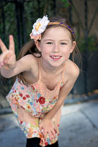 Close-up portrait of smiling girl with flowers