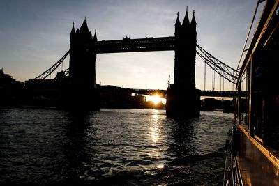 Bridge over river at sunset