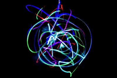 Close-up of light painting against black background