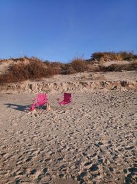 Scenic view of sand on beach against clear sky