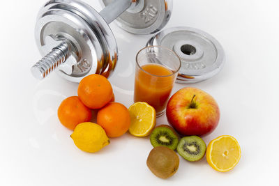 High angle view of fruits on table against white background