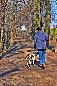 Rear view of woman walking on footpath