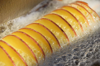 Close-up of fruit slices in oil