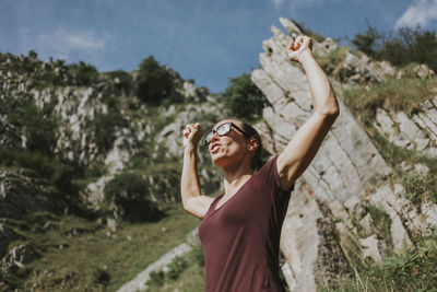 Woman holding a while standing outdoors