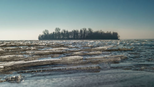 Scenic view of frozen lake against clear sky